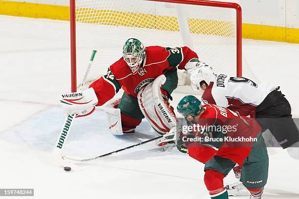 Niklas Backstrom of the Minnesota Wild defends his goal against Matt Duchene of the Colorado Avalanche during the game on January 19, 2013 at the...