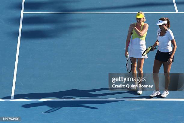 Iva Majoli of Croatia and Barbara Schett Austria talk tactics in their legends doubles match against Martina Navratilova of the United States of...