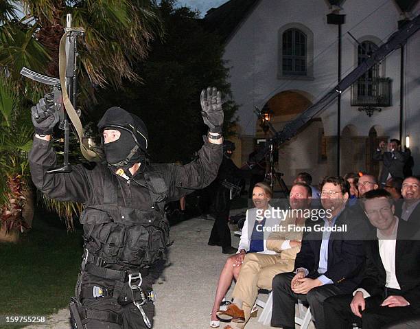Fake swat team enters the mansion grounds on the first anniversary of the police raid which saw the closure of Megaupload, as Kim Dotcom launches his...