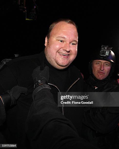 Kim Dotcom fools around with a fake swat team as he launches his new file-sharing site, Mega, on January 20, 2013 in Auckland, New Zealand. The...