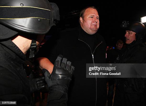 Kim Dotcom fools around with a fake swat team as he launches his new file-sharing site, Mega, on January 20, 2013 in Auckland, New Zealand. The...