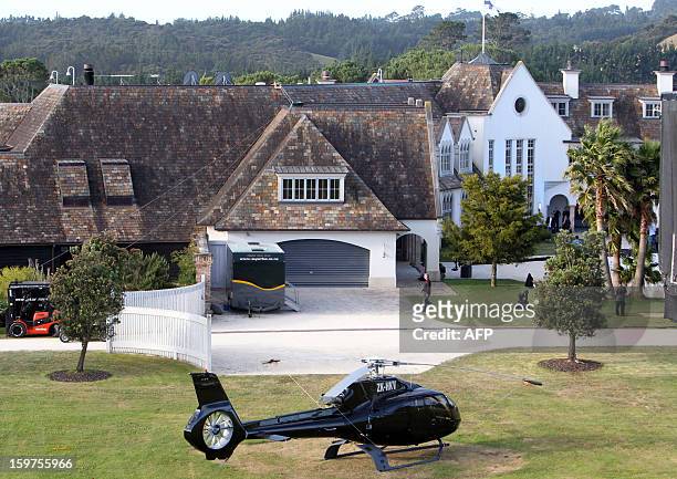 This general view shows a helicopter parked outside the mansion of Megaupload founder Kim Dotcom before the launch of his new website at a press...