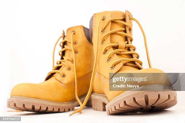 yellow boots - laarzen geel stockfoto's en -beelden
