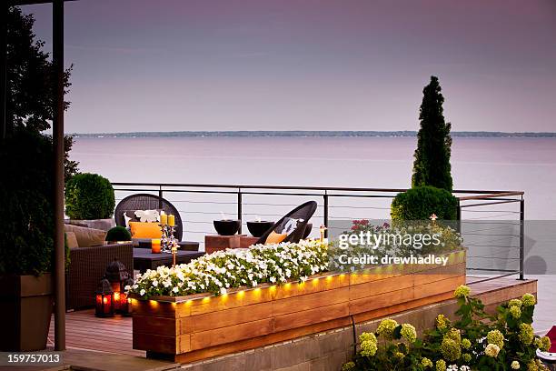 patio over looking the lake at sunset. - string light stock pictures, royalty-free photos & images