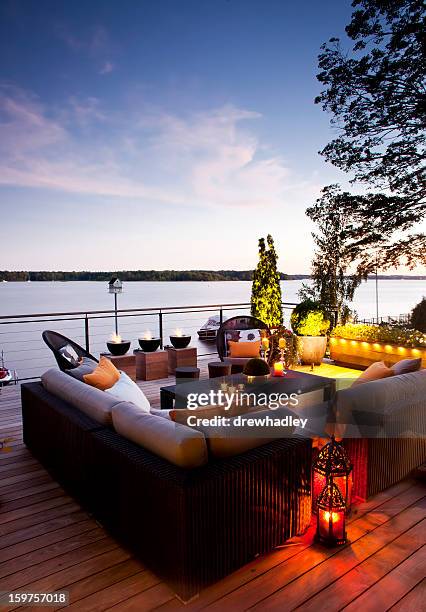 patio over looking the lake at sunset. - patio furniture stock pictures, royalty-free photos & images