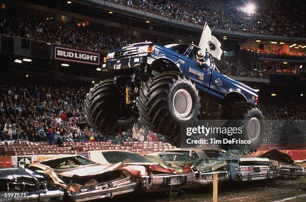 Bigfoot flies over cars during the monster truck rally at Anaheim Stadium in 1989 in Anaheim, California. Photo by: Tim Defrisco/Getty Images