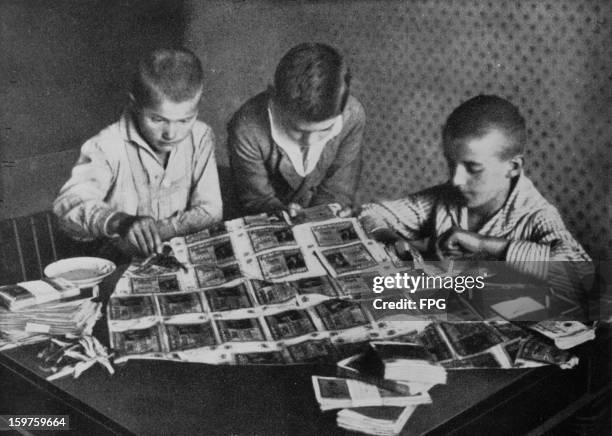 Children playing with paper money, which is rendered virtually worthless by a period of post-war hyperinflation in Germany, circa 1923.