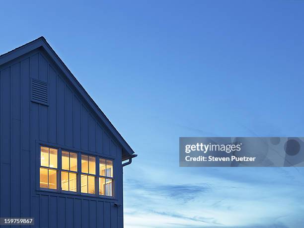 lit windows of home at dusk - heaven light stock pictures, royalty-free photos & images