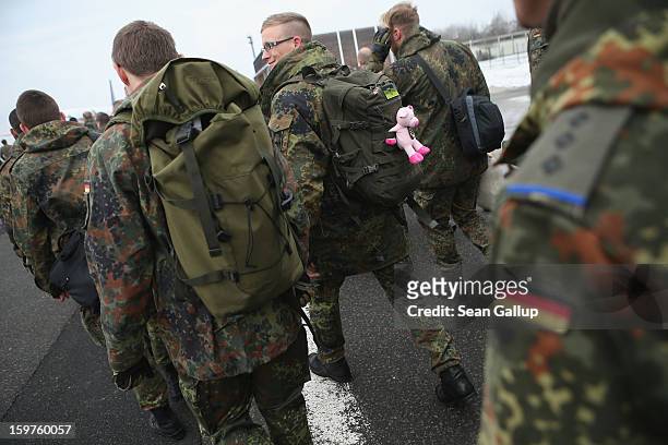 Contingent of approximately 240 soldiers of the German Bundeswehr, including one with a stuffed, pink pig attched to his rucksack, prepare to board a...