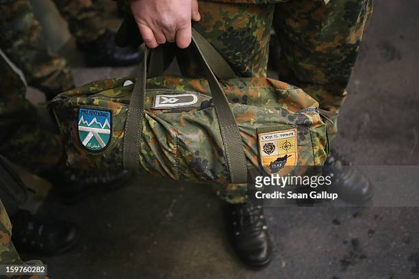 Contingent of approximately 240 soldiers of the German Bundeswehr, including one carrying a bag that shows previous service in Afghanistan, gather to...