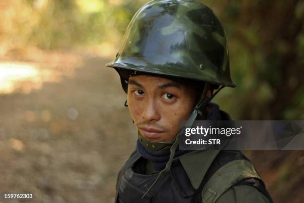 Rebel Kachin Independence Army 3rd Brigade soldier stands guard as they secure an area on Hka Ya mountain in Kachin province on January 20, 2013....