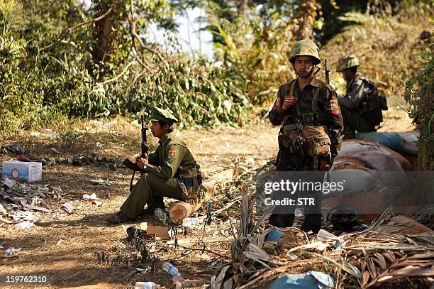 Rebel Kachin Independence Army 3rd Brigade soldiers stand guard as they secure an area on Hka Ya mountain in Kachin province on January 20, 2013....