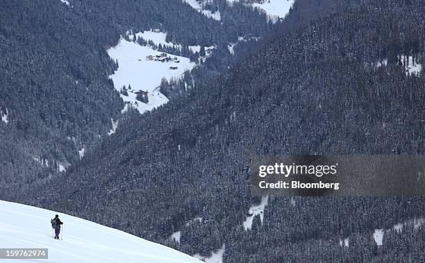 Walker moves across powder snow in the Schatzalp area high above the town of Davos, Switzerland, on Saturday, Jan. 19, 2013. Next week the business...