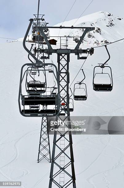 Empty seats are seen on the Schatzalp chair lift as it moves down the mountain in the town of Davos, Switzerland, on Saturday, Jan. 19, 2013. Next...