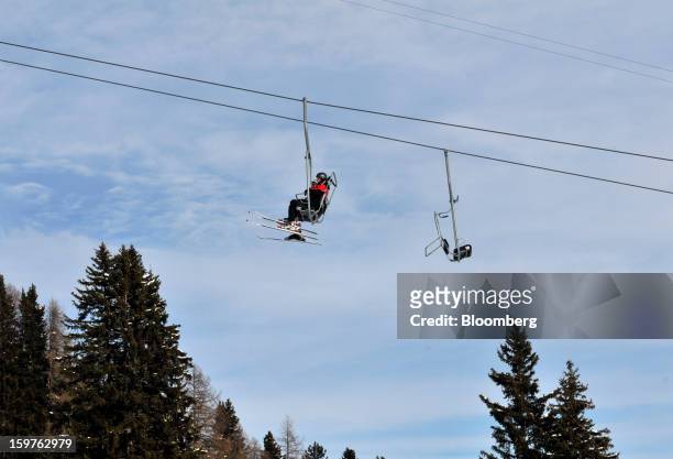 Skiers ride on the Schatzalp chair lift as it moves up the mountain in in the town of Davos, Switzerland, on Saturday, Jan. 19, 2013. Next week the...