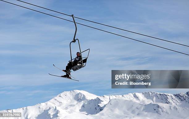 Skier rides on the Schatzalp chair lift as it moves up a mountain in the town of Davos, Switzerland, on Saturday, Jan. 19, 2013. Next week the...