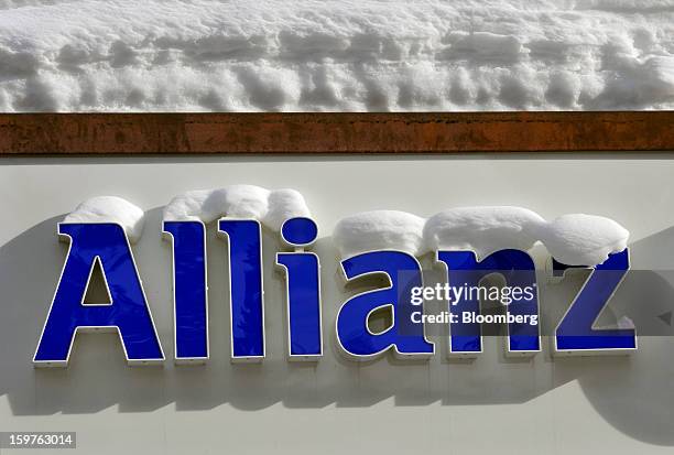 Logo for Allianz SE, Europe's biggest insurer sits covered in snow outside of a branch in the town of Davos, Switzerland, on Saturday, Jan 19, 2013....