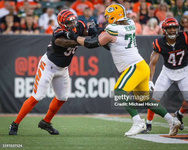 Defensive end Raymond Johnson III of the Cincinnati Bengals rushes against guard Royce Newman of the Green Bay Packers at Paycor Stadium on August...