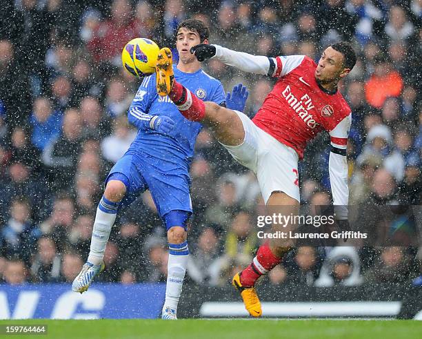 Francis Coquelin of Arsenal challenges Oscar of Chelsea during the Barclays Premier League match between Chelsea and Arsenal at Stamford Bridge on...