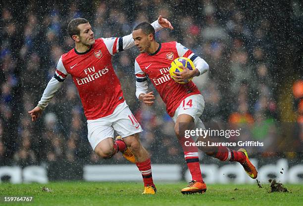 Theo Walcott of Arsenal celebrates with Jack Wilshere of Arsenal as he scores their first goal during the Barclays Premier League match between...