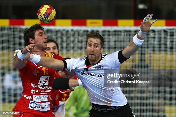 Oliver Roggisch of Germany defends against Filip Mirkulovski of Macedonia during the round of sixteen match between Germany and Macedonia at Palau...