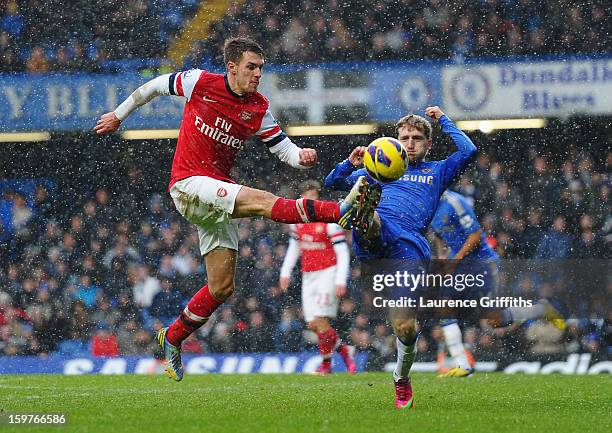 Aaron Ramsey of Arsenal challenges Marko Marin of Chelsea during the Barclays Premier League match between Chelsea and Arsenal at Stamford Bridge on...