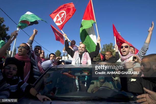 Former Palestinian prisoner Jihad Abedi is greeted as he is driven through a neighborhood of Jerusalem following his release from an Israeli jail...