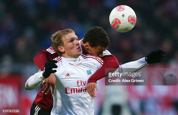 Artjoms Rudnevs of Hamburg is challenged by Timothy Chandler of Nuernberg during the Bundesliga match between 1. FC Nuernberg and Hamburger SV at...