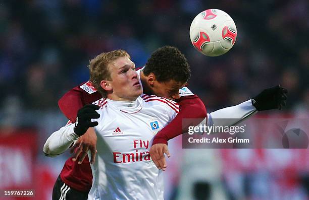 Artjoms Rudnevs of Hamburg is challenged by Timothy Chandler of Nuernberg during the Bundesliga match between 1. FC Nuernberg and Hamburger SV at...