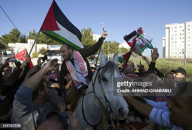 Former Palestinian prisoner Jihad Abedi rides on a horse through a neighborhood of Jerusalem following his release from an Israeli jail after serving...