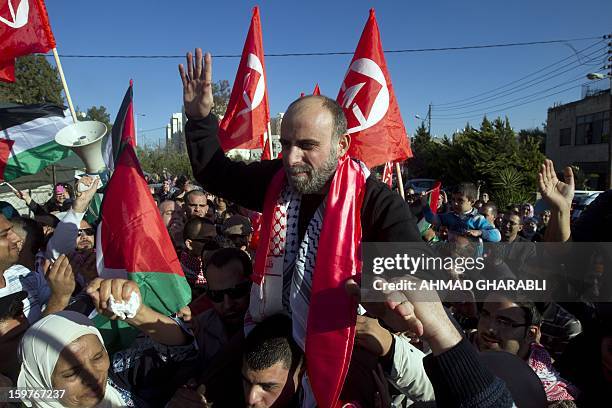 Former Palestinian prisoner Jihad Abedi is carried on the shoulders of friends and relatives as he arrives in neighborhood of Jerusalem following his...