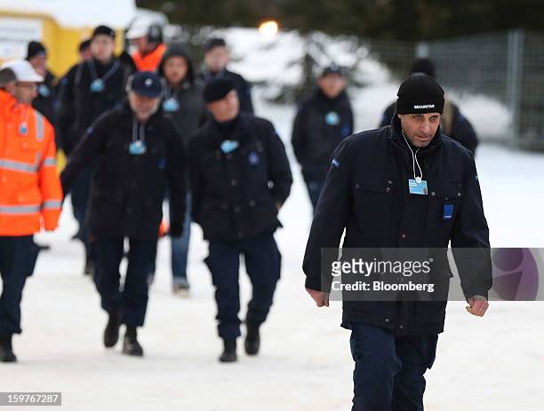 Security officers arrive at an entrance to the Congress Centre ahead of the World Economic Forum meeting in Davos, Switzerland, on Sunday, Jan. 20,...