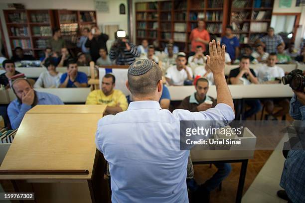 Naftali Bennett , head of HaBayit HaYehudi Party, the Jewish Home party, talks to students at a pre-army training school as he campaigns in the...