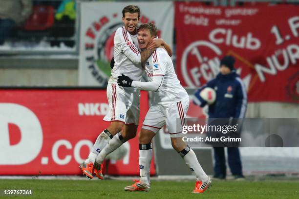 Artjoms Rudnevs of Hamburg celebrates his team's first goal with team mate Dennis Diekmeier during the Bundesliga match between 1. FC Nuernberg and...