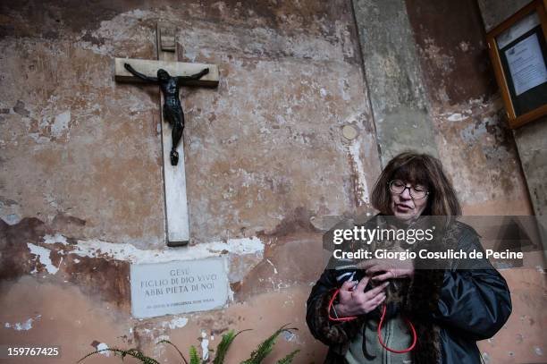 Cat and its owner wait for the start of a traditional mass for the blessing of animals at the Sant'Eusebio church on January 20, 2013 in Rome, Italy....