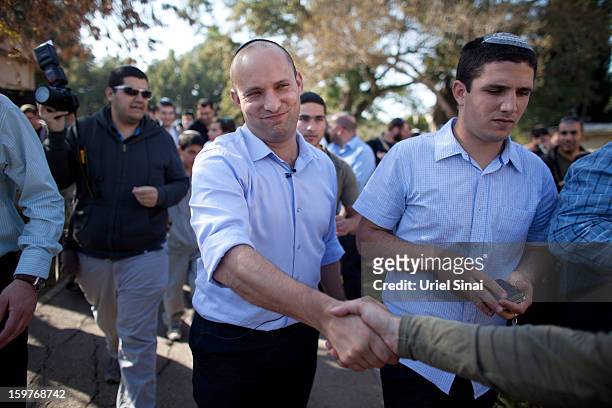 Naftali Bennett, head of HaBayit HaYehudi Party, the Jewish Home party, talks to students at a pre-army training school as he campaigns at the...