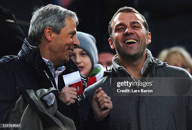 Lucien Favre, head coach of Borussia Moenchengladbach, smiles with Hans Dieter Flick, assistant coach of German National team, during the Bundesliga...