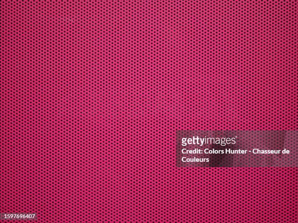 a perforated metal plate painted dark pink in paris, france - metal grate fotografías e imágenes de stock