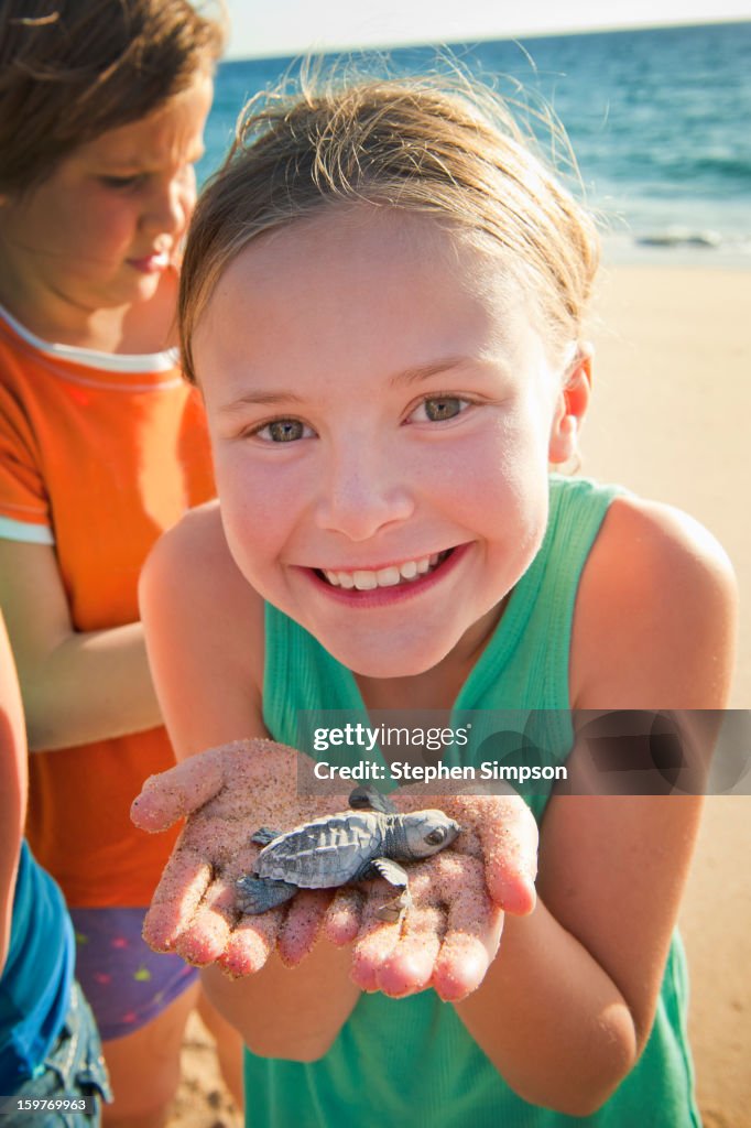 Girls about to release Pacific Green Sea Turtles