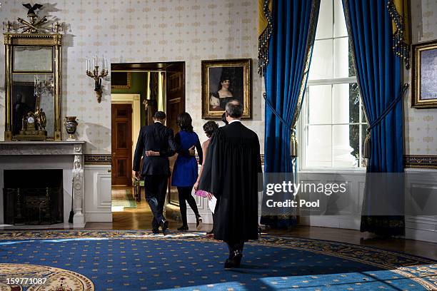 President Barack Obama walks with daughters Malia and Sasha after being sworn in by U.S. Supreme Court Chief Justice John Roberts Jr. In the Blue...