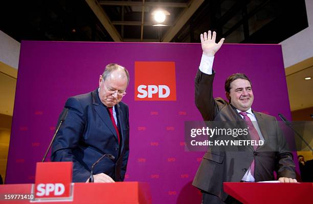 Sigmar Gabriel , SPD party chairman and SPD chancellor candidate Peer Steinbrueck address supporters in Berlin on January 20, 2013 on polling day of...