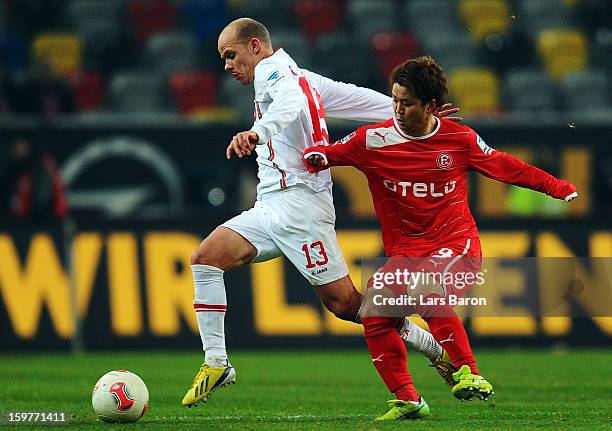 Tobias Werner of Augsburg is challenged by Genki Omae of Duesseldorf during the Bundesliga match between Fortuna Duesseldorf 1895 and FC Augsburg at...