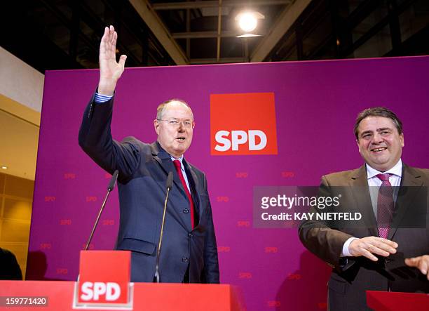 Sigmar Gabriel , SPD party chairman and SPD chancellor candidate Peer Steinbrueck address supporters in Berlin on January 20, 2013 on polling day of...