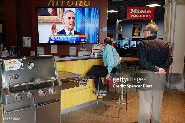 People watch the swearing-in of U.S. President Obama at Aitoro appliance store on January 20, 2013 in Norwalk, Connecticut. Both President Obama and...