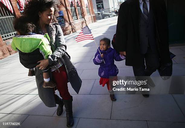 Ariana Smith carries an American flag as mother Ana Blanco-Smith carries Christian Smith as Washington prepares for President Barack Obama's second...