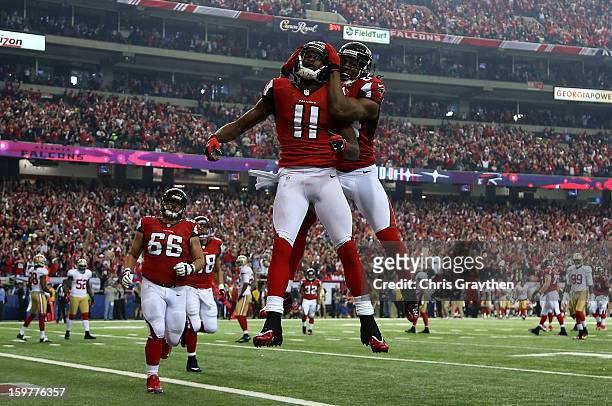 Wide receiver Julio Jones and wide receiver Roddy White of the Atlanta Falcons celebrate after Jones catches a 20-yard touchdown catch in the second...