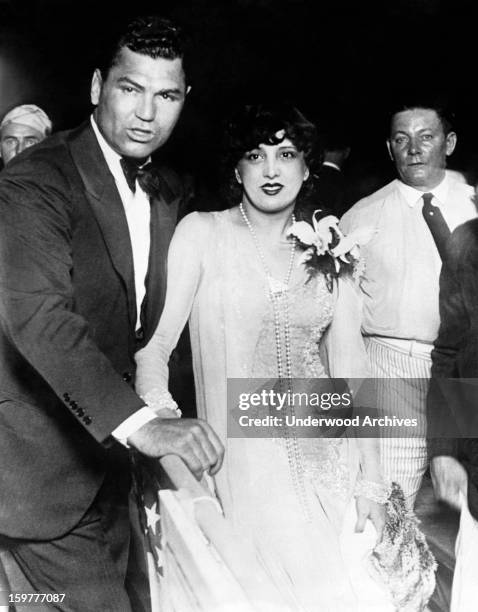 Former heavyweight champion Jack Dempsey and his wife, actress Estelle Taylor, are photographed ringside at the Sharkey-Stribling fight which Dempsey...