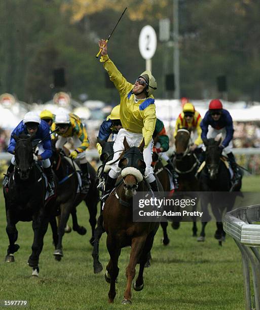 Damien Oliver celebrates on 'Media Puzzle' after winning the 2002 Tooheys New Melbourne Cup at Flemington Racecourse in Melbourne, Australia on...