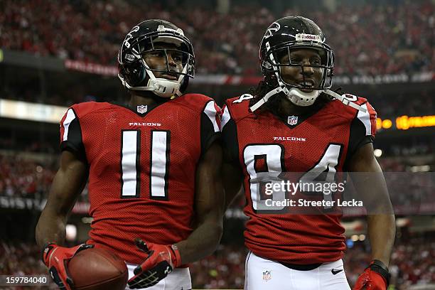 Wide receiver Julio Jones and wide receiver Roddy White of the Atlanta Falcons celebrate after Jones catches a 20-yard touchdown catch in the second...