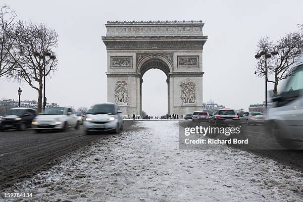Snow covers the ground around the Arc de Triomphe on January 19 in Paris, France. Heavy snowfall fell throughout Europe and the UK causing travel...